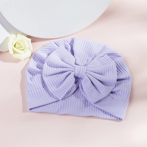 Detail of light purple ribbed cotton baby turban hat with a large decorative bow