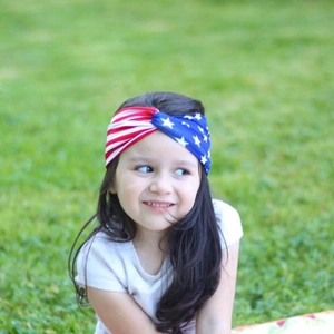 Detail of child wearing American flag bunny ear headband with red stripes and stars