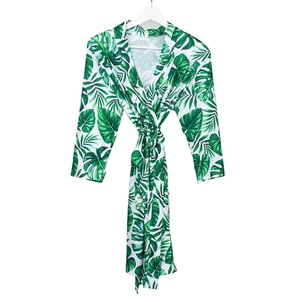 Detail of soft maternity robe featuring a green tropical palm leaf print and waist tie
