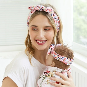 Close-up of pink floral bunny ear headbands for mother and baby in soft elastic fabric