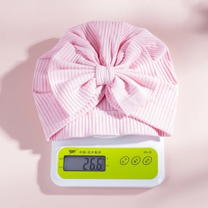 Pink ribbed cotton baby turban hat with oversized bow decoration weighing 26.6 grams