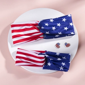 Macro detail of USA flag headband set and heart rhinestone earrings on a display tray