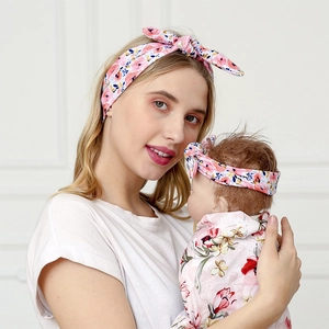 Mom and baby matching set with floral bunny ear headband and soft swaddle wrap