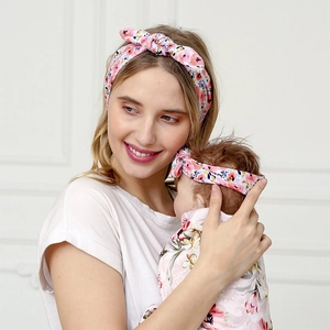 Floral knit mother and baby headband set with matching swaddle wrap for newborns