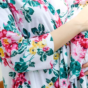 Detailed close-up of floral print pattern on maternity hospital robe in soft cotton fabric