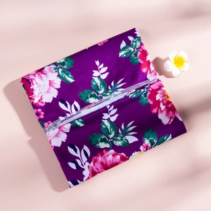 Detail of purple floral maternity fabric with peonies and precise stitching edge