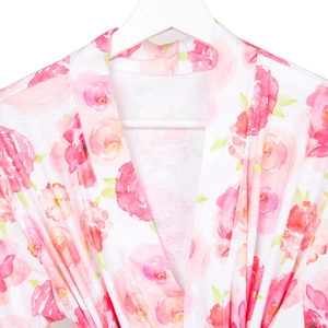 Detail of V-neck maternity robe with pink rose floral print on white lightweight fabric
