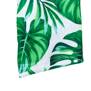 Detailed close-up of tropical leaf print fabric and double-needle stitching on robe