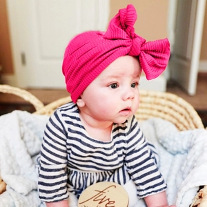 Rose pink ribbed cotton baby turban hat with oversized bow decoration for infants