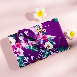 Floral swaddle blanket and bow headband set for newborns in soft purple fabric