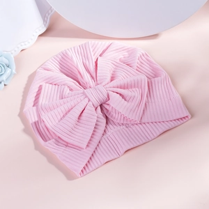 Pink ribbed cotton baby turban hat with a large bow for newborn girl's warm accessory