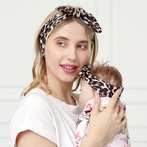 Close-up of leopard print mother and baby headband set with knotted bow details