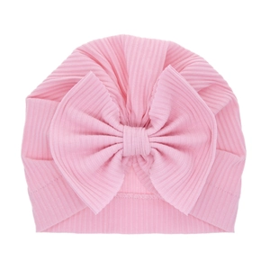 Pink ribbed baby turban hat with a large bow detail for infants and toddlers