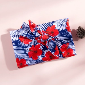 Détail d'un bandeau à imprimé tropical avec fleurs d'hibiscus et motifs de palmiers