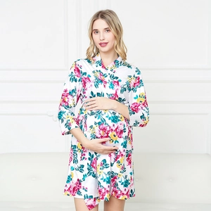 Close-up of floral print maternity robe featuring vibrant red and yellow flowers