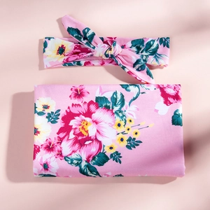 Floral print baby swaddle blanket with matching bow headband set for newborns and infants