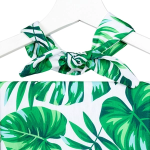 Close-up of tropical monstera leaf print maternity dress with neck bow on a white hanger