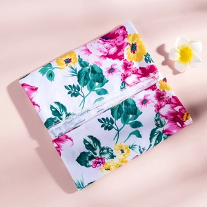 Detail view of floral swaddle blanket set with precise overlock stitching and soft pink print