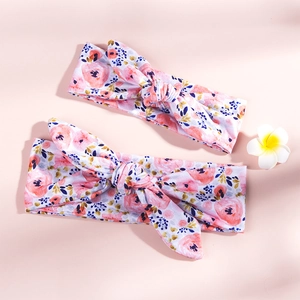 Detailed view of floral printed bunny ear headbands with pink roses and knot design
