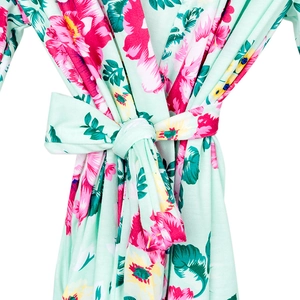Detail of floral maternity robe with soft mint fabric and colorful flower patterns