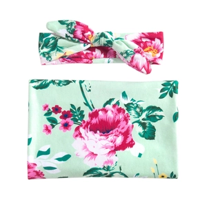 Floral print baby swaddle blanket and matching bow headband set in mint green and pink