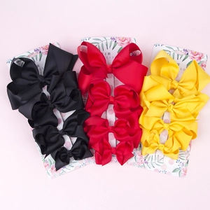Three-pack set of boutique grosgrain ribbon hair bows in black, red, and yellow colors