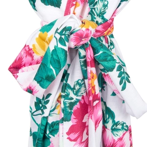 Detail of floral print maternity robe fabric featuring pink and yellow flowers on white
