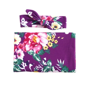 Floral baby swaddle blanket and matching bow headband set in dark purple fabric