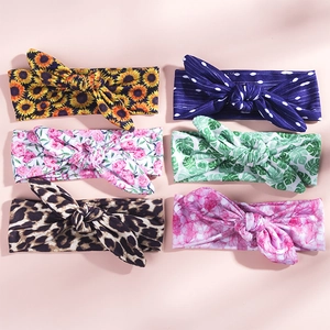 Detailed view of six colorful rabbit ear knot headbands with floral and leopard prints