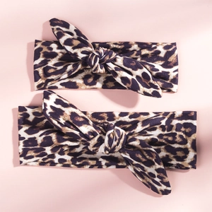 Flat lay of leopard print rabbit ear headband set with soft elastic fabric texture