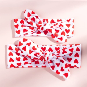Detail of red heart print knotted rabbit ear headbands in a soft cotton fabric set