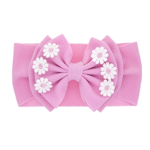 Bandeau bébé en tricot gaufré rose avec grand nœud double et fleurs de marguerites blanches