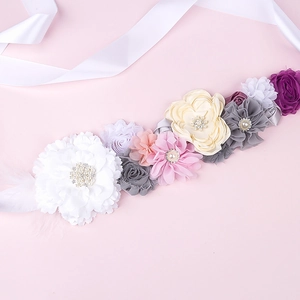 Detail of baby shower sash featuring handmade floral petals with pearls and rhinestones