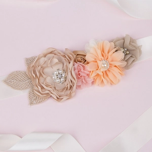 Detail of floral maternity belt with satin ribbon pearls and rhinestones for photography