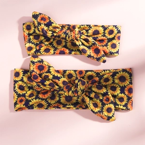 Detail of sunflower print knot headbands in two sizes with soft elastic fabric texture