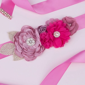 Detail of pink floral maternity sash with satin flowers, pearls and rhinestones
