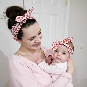 Matching mother and baby headband set featuring red heart print and adjustable bow knot