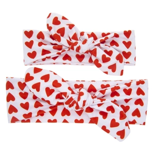 Matching mother and child rabbit ear headbands with red heart prints on white fabric
