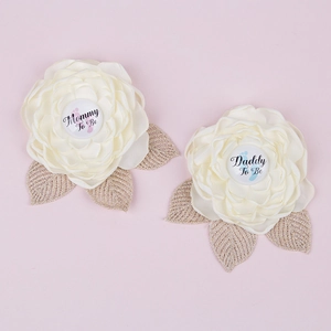 Detail of Mommy To Be and Daddy To Be satin flower pins for baby shower party