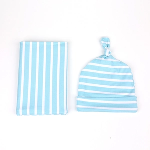 Detail of light blue striped newborn swaddle wrap and matching knotted hat set