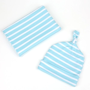 Flat lay of blue and white striped cotton baby swaddle blanket with matching knotted hat