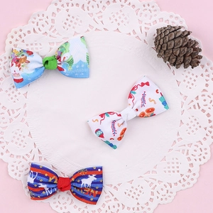 Detailed macro view of three Christmas hair clips with reindeer and bell bow patterns