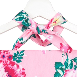 Detail of floral maternity robe with pink flowers and a halter bow tie on a hanger