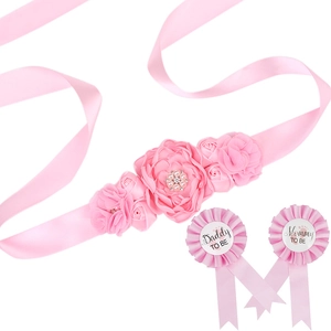 Close-up of pink floral maternity sash with Daddy To Be and Mommy To Be badges set