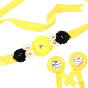 Yellow flower belly band with Mommy to be and Daddy to be badges for baby shower