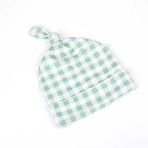 Detailed view of baby knot beanie in green gingham print with soft cotton fabric