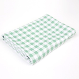 Detail of green and white plaid pattern fabric for newborn baby swaddle and knotted hat