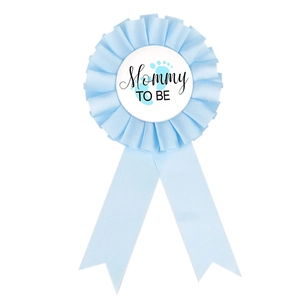 Close-up of light blue Mommy TO BE baby shower ribbon badge with satin floral design