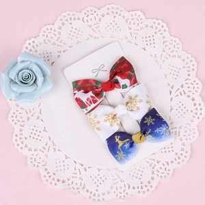 Set of 3 Christmas hair clips with reindeer and snowflake patterns on ribbon bows