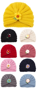 Detailed grid of knitted infant hats in vibrant colors featuring 3D floral accents